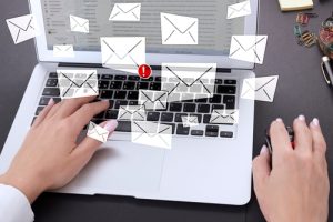 Laptop, hands on keyboard and email icons with PHISHING ALERT warning scam, spam, malware, spyware