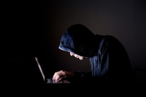 hacker with laptop email spoofing concept