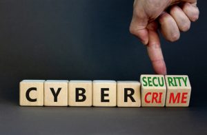 Businessman turns wooden cubes, changes words Cybercrime to cyber-security Cybersecurity vs cybercrime concept