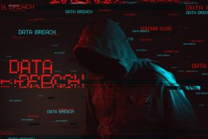 Data breach concept with faceless hooded hacker