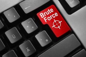 dark grey keyboard red button brute force attack concept