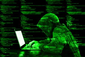 hacker typing on laptop cybercrime concept